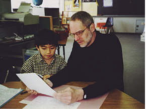 George helping a young writer with a story.