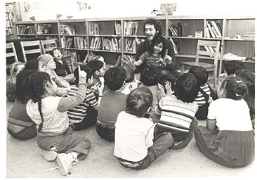 George telling a strory to a class.